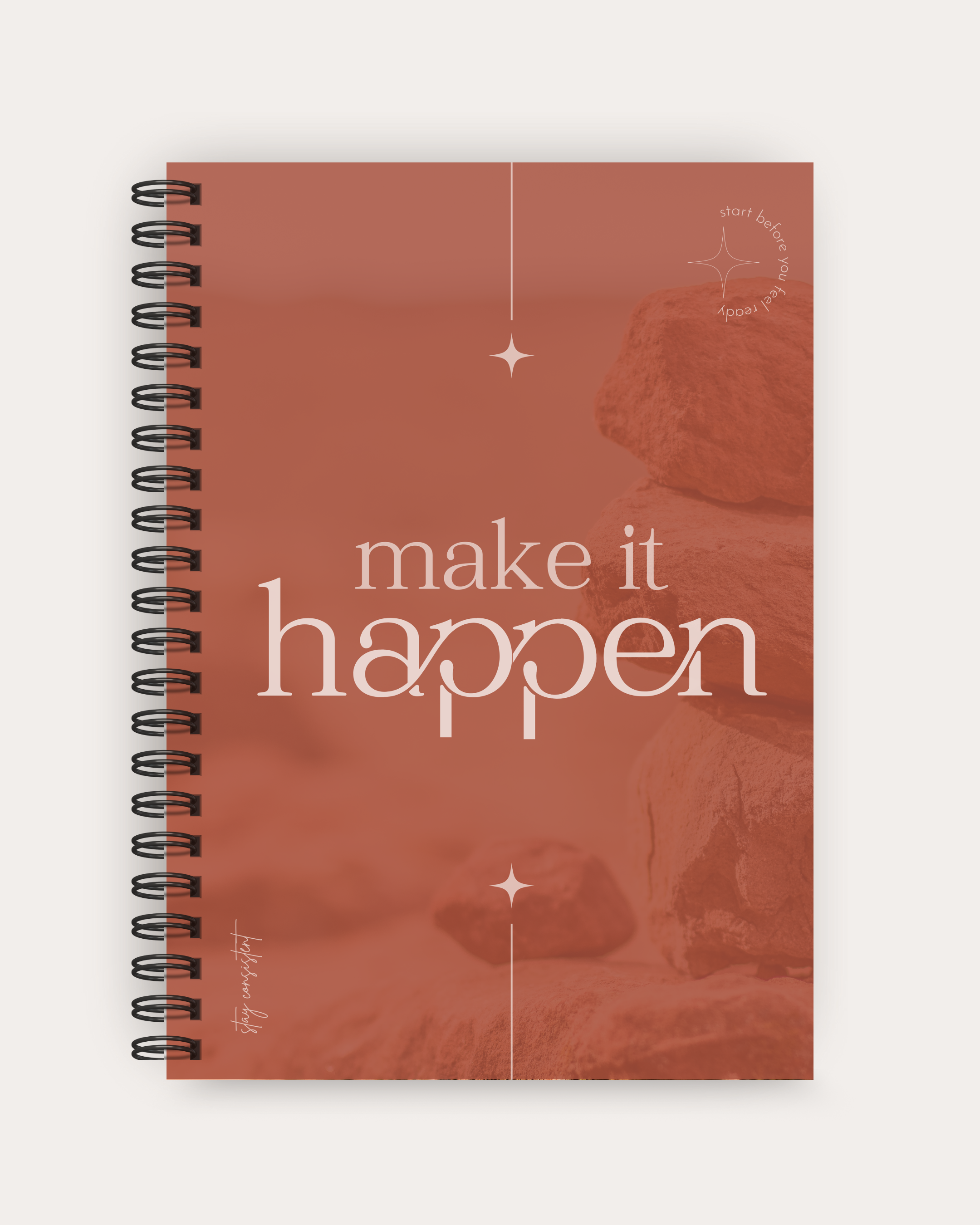 Spiral-bound notebook with 'make it happen' text on a red background