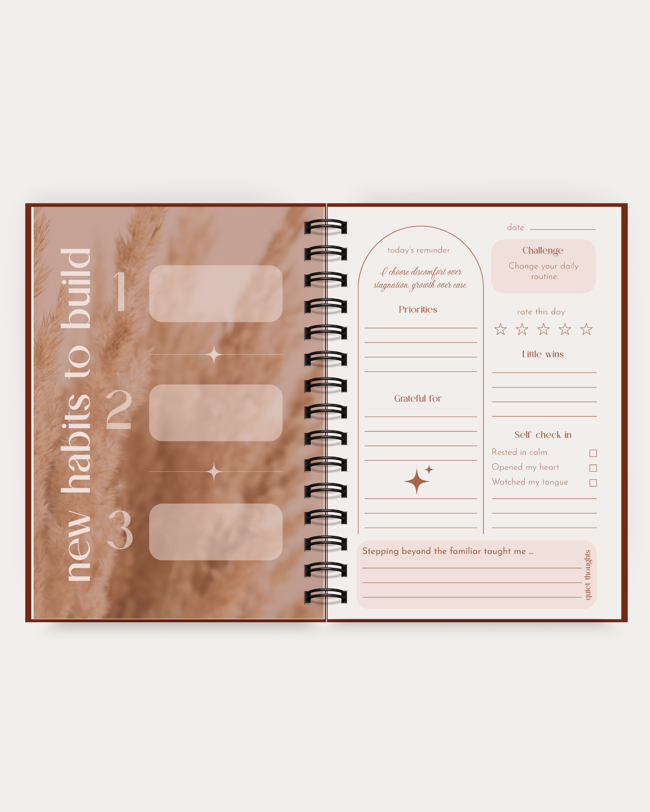 Open spiral-bound planner with habit tracking pages on a white background