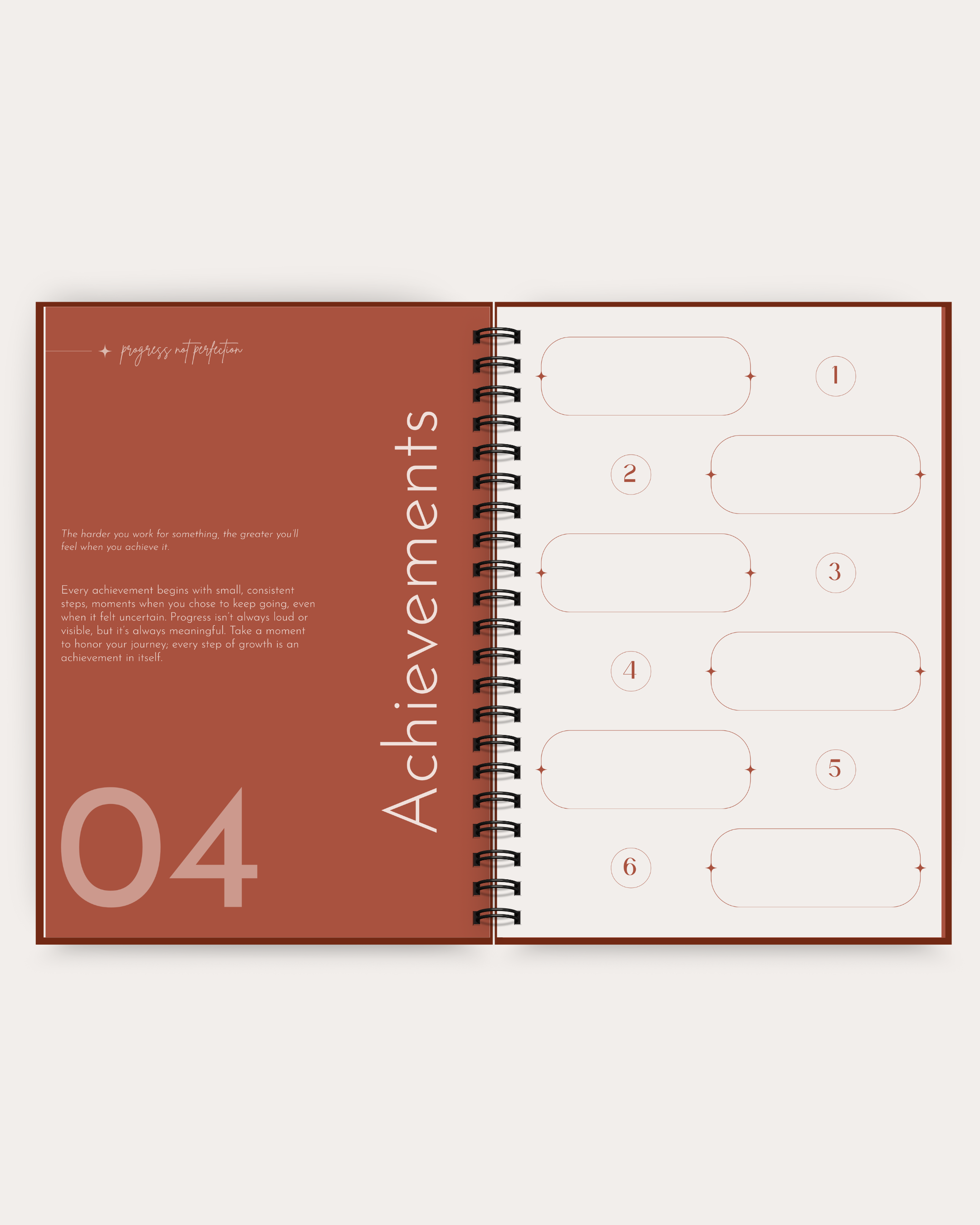 Open spiral-bound planner with 'Achievements' section on a white background