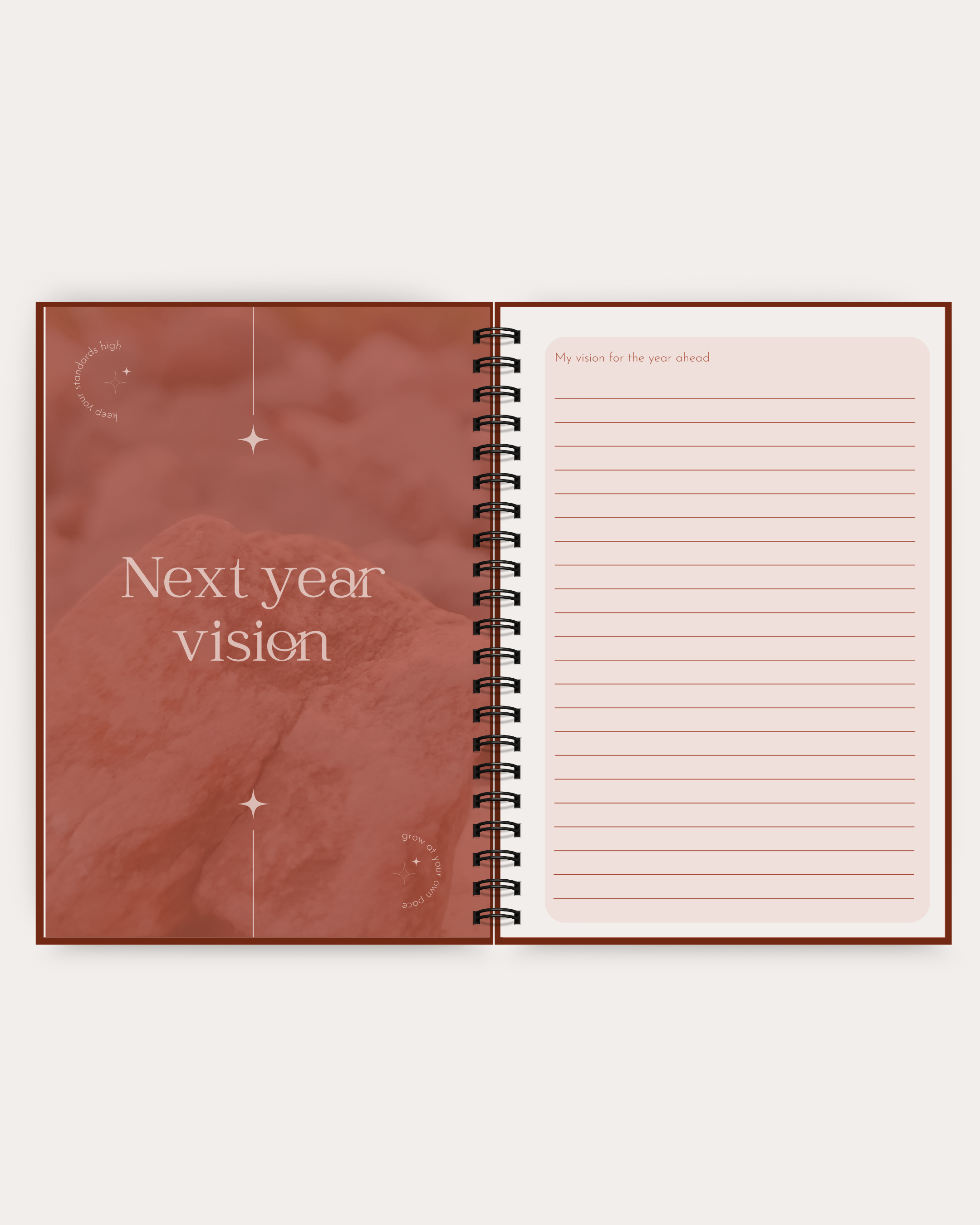 Open spiral-bound notebook with 'Next year vision' on a maroon cover