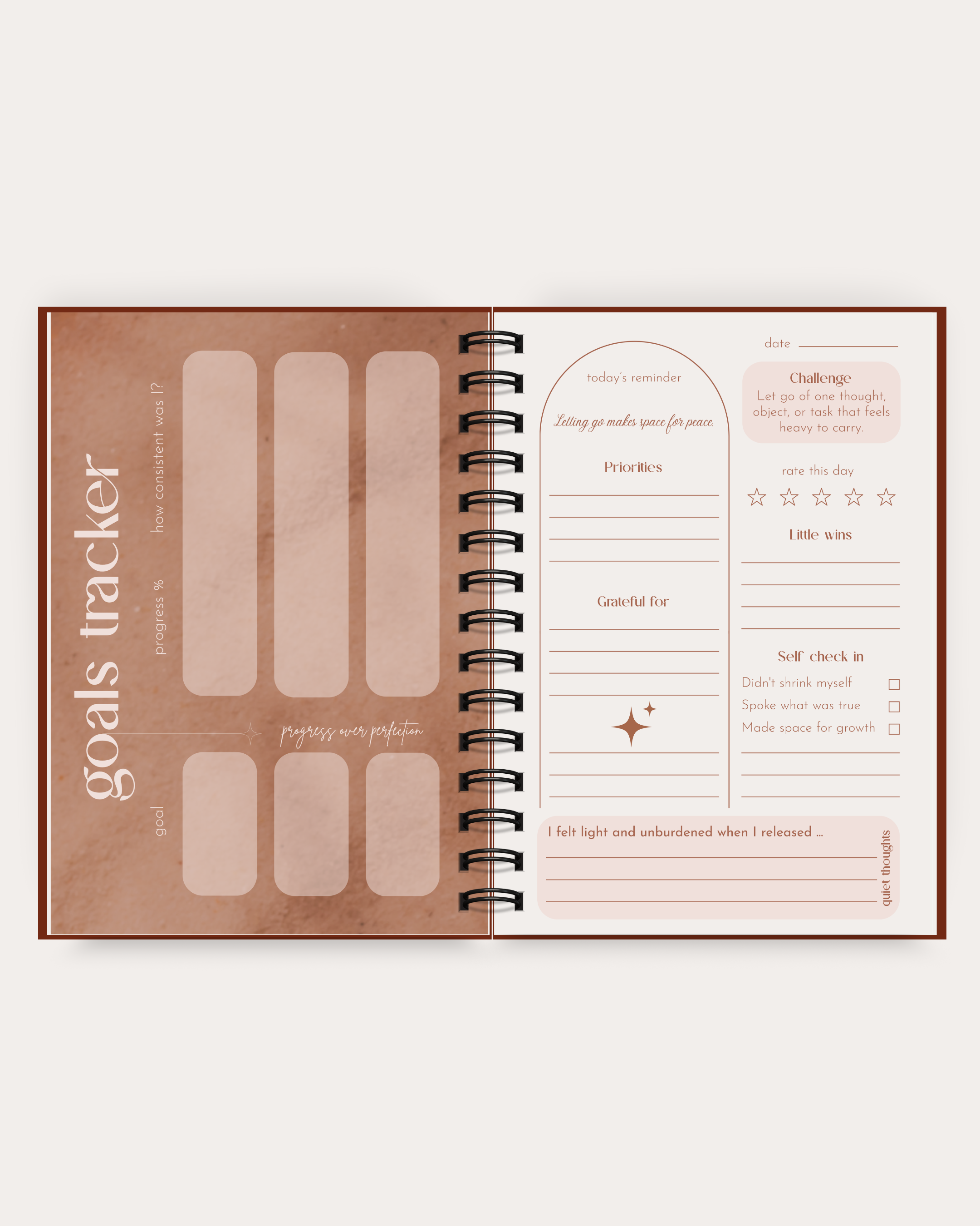 Goals tracker notebook with spiral binding on a white background
