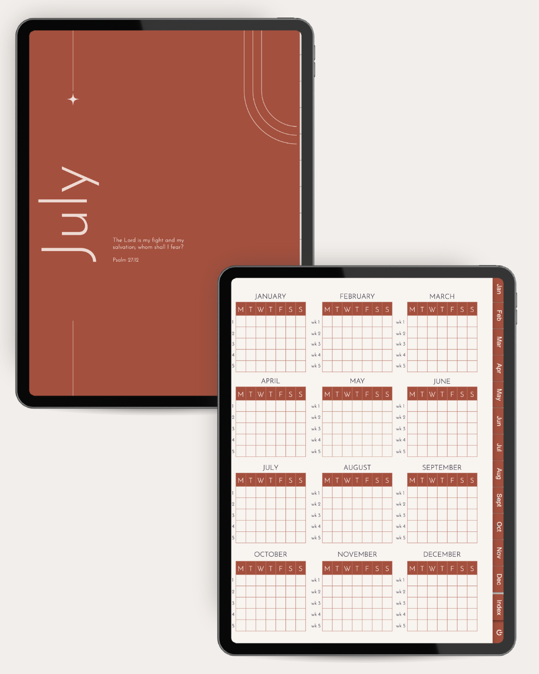 Two black tablet devices shown on a light gray background. The larger tablet displays a rust-brown cover with the word 'July' and a Bible verse, while the smaller tablet in front shows a monthly calendar grid in the same rust and cream color scheme.
