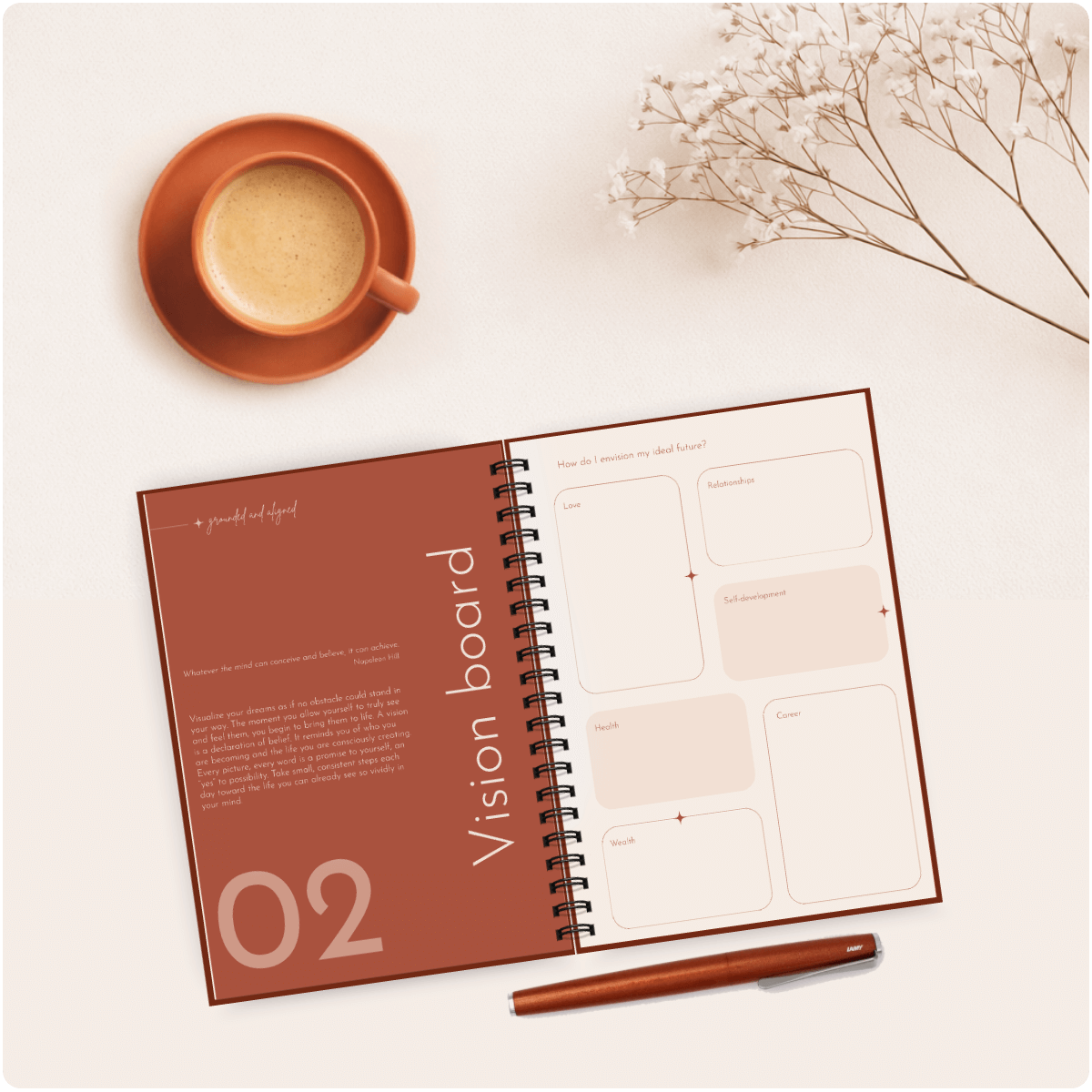 Open planner with 'Vision board' section, cup of coffee, and pen on a light surface.