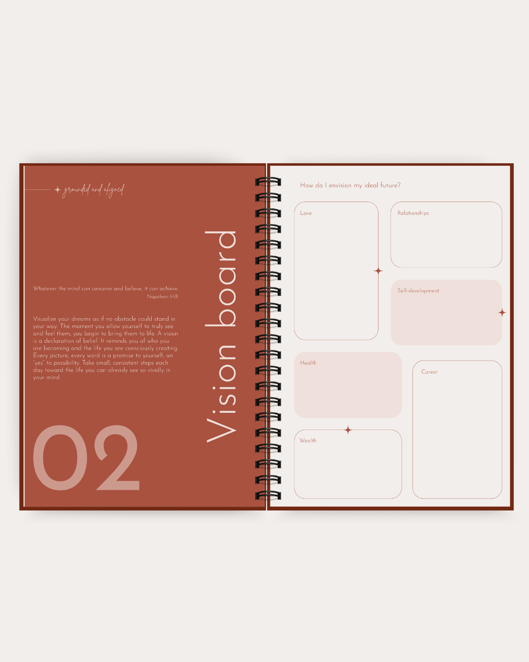 An open spiral-bound notebook or planner spread showing a warm brown left page with the text 'Vision board' and '02', plus pale pink labeled boxes on the right page.
